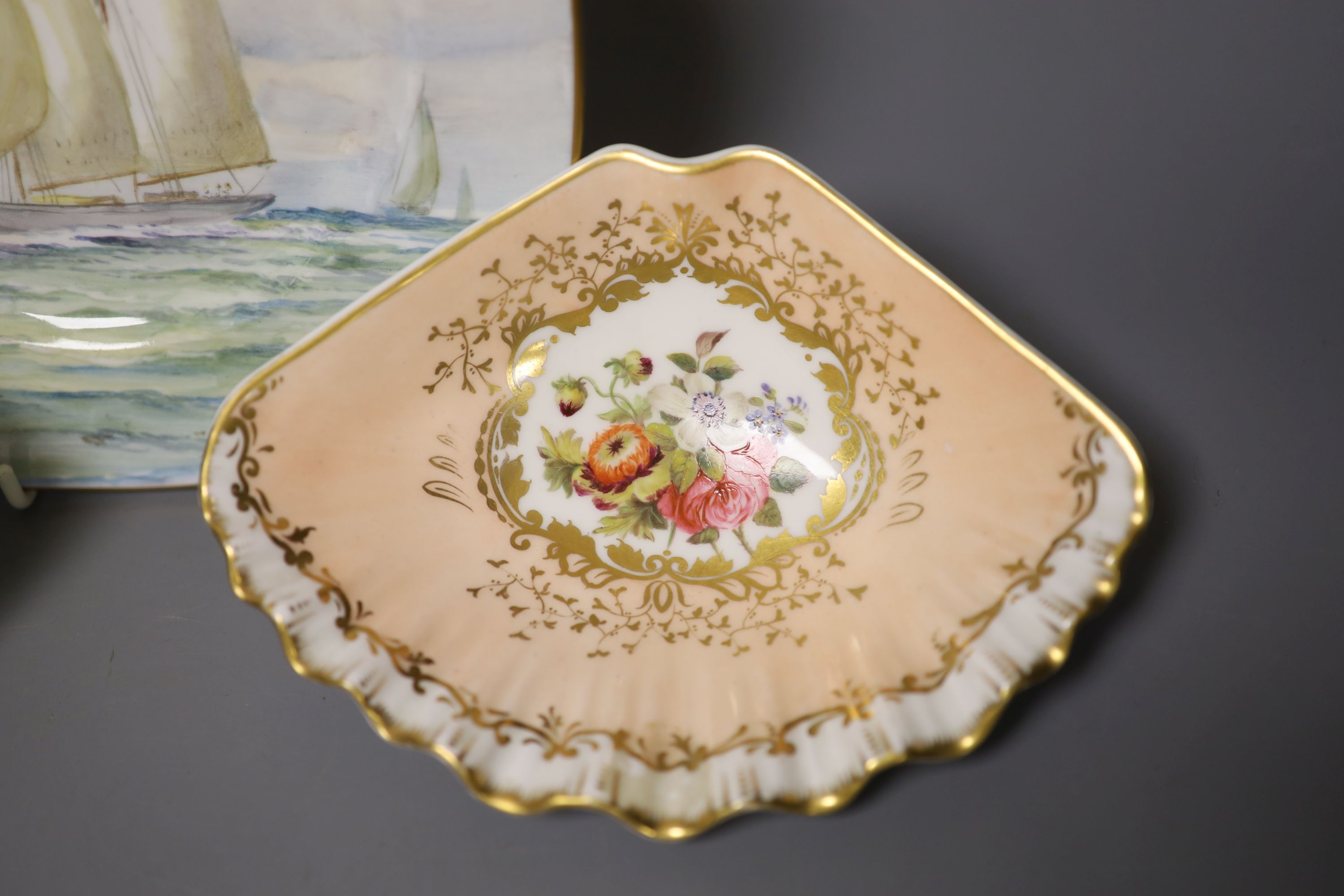 A Royal Crown Derby square shaped plate, painted with a yachting scene by WEJ Dean, and pair of Crown Derby scallop dishes